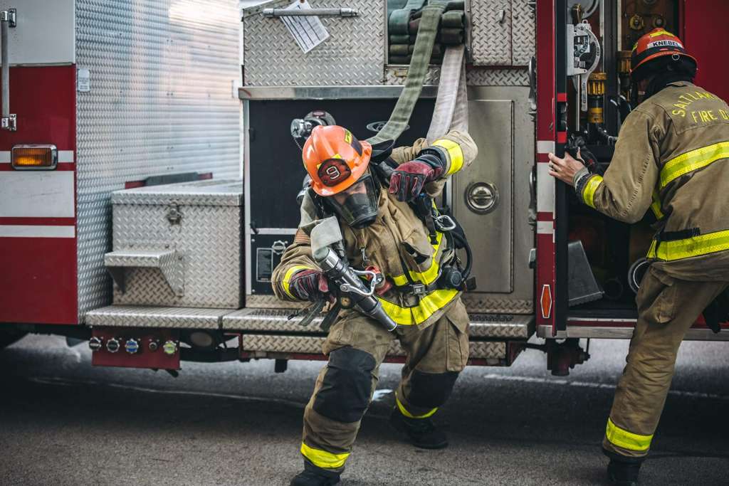 A recruit pulling hose at SLC Fire Academy.