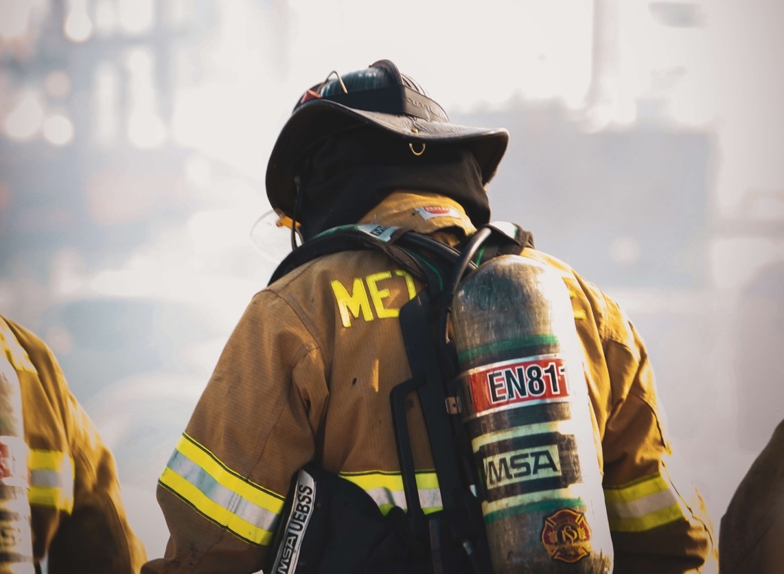 Firefighter walking through smoke